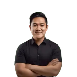 Portrait of a smiling man with short dark hair, arms crossed, wearing a black short-sleeved shirt